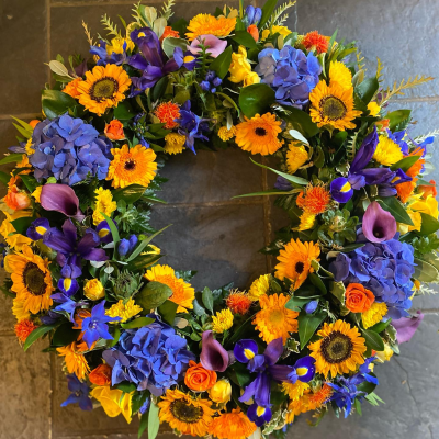 Wreath SYM-317 - A classic wreath arranged using mixed flowers. Wreath SYM-317 - A classic wreath arranged using mixed flowers.